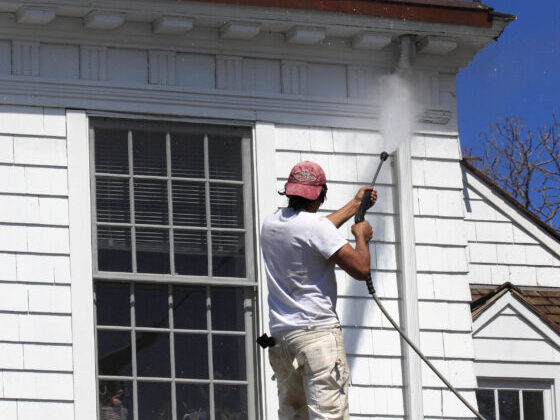 Power washing exterior of Hamptons home siding