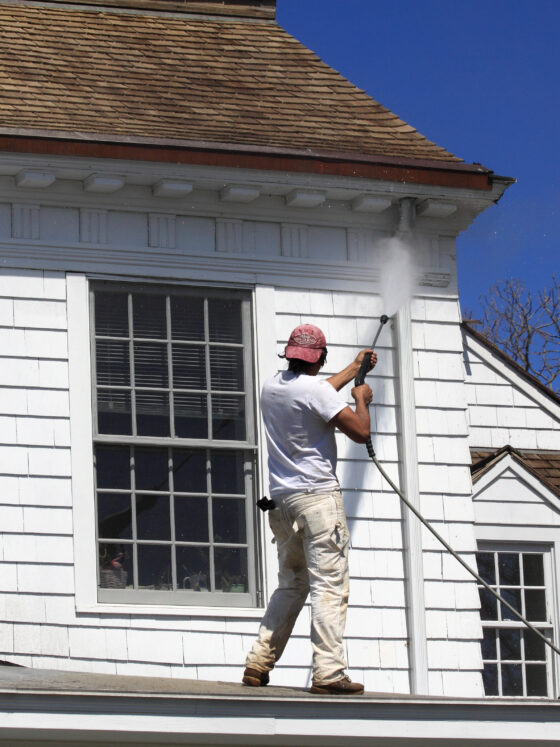 Power washing exterior of Hamptons home siding
